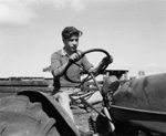 011863D: Driving a tractor, Fairbridge Farm, 1954