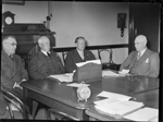 Taking evidence. The Royal Commission which is inquiring into the proposed establishment of a national power scheme at Collie to serve the South West sat at Parliament House, 11 October 1939. Left to right: W. H. Taylor, F. E. Shaw (Chairman), F. C. Edmondson and W. J. Mann M.L.C. giving evidence [picture]
