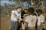 134034PD: David Smith paying Aborigines for collecting sandalwood at Cundeelee, May 1957