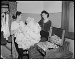 Miss Ann Donald and Beth Dean unpacking costumes for the J. C. Williamson production of Annie Get Your Gun at His Majesty's Theatre, Perth, 10 April 1950 [picture]