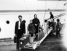 005090D: An immigrant family with luggage disembark, May 1953