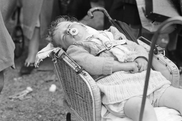 Young girl asleep in pram at the Royal Show 1938