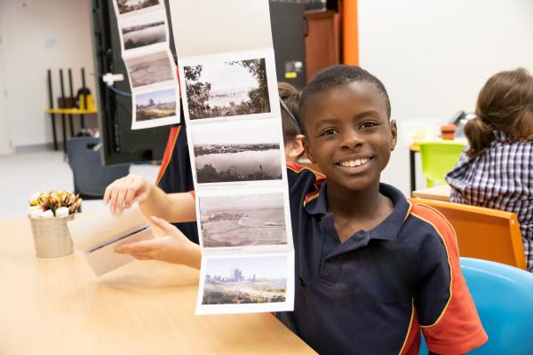 Primary School student showing off his activity work