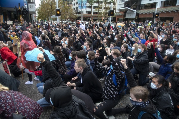 Protestors take the knee - in deference to George Floyds death at the hands of a police officer - for one minute at the intersection of St Georges Terrace and Barrack Street during the march at the 2nd Black Lives Matter protest rally