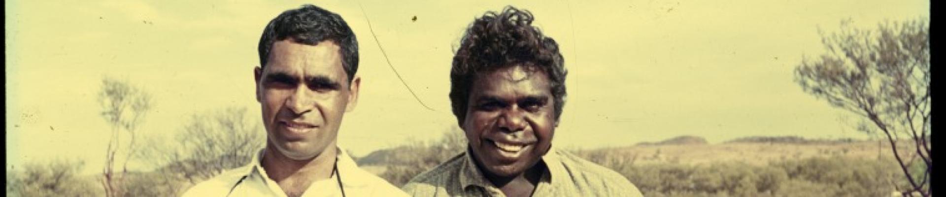 Ron Williams holding a guitar with another Aboriginal man